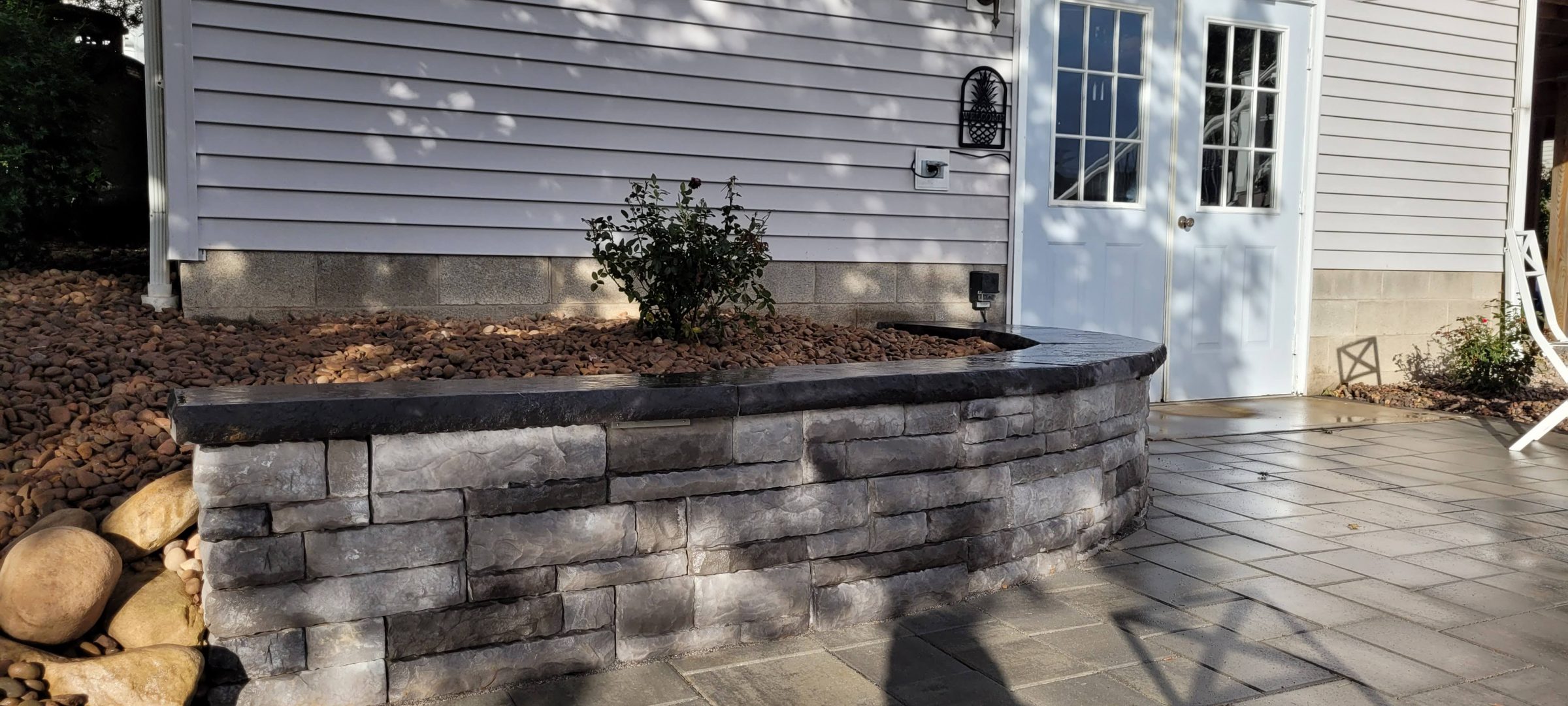 Stone retaining wall with small garden