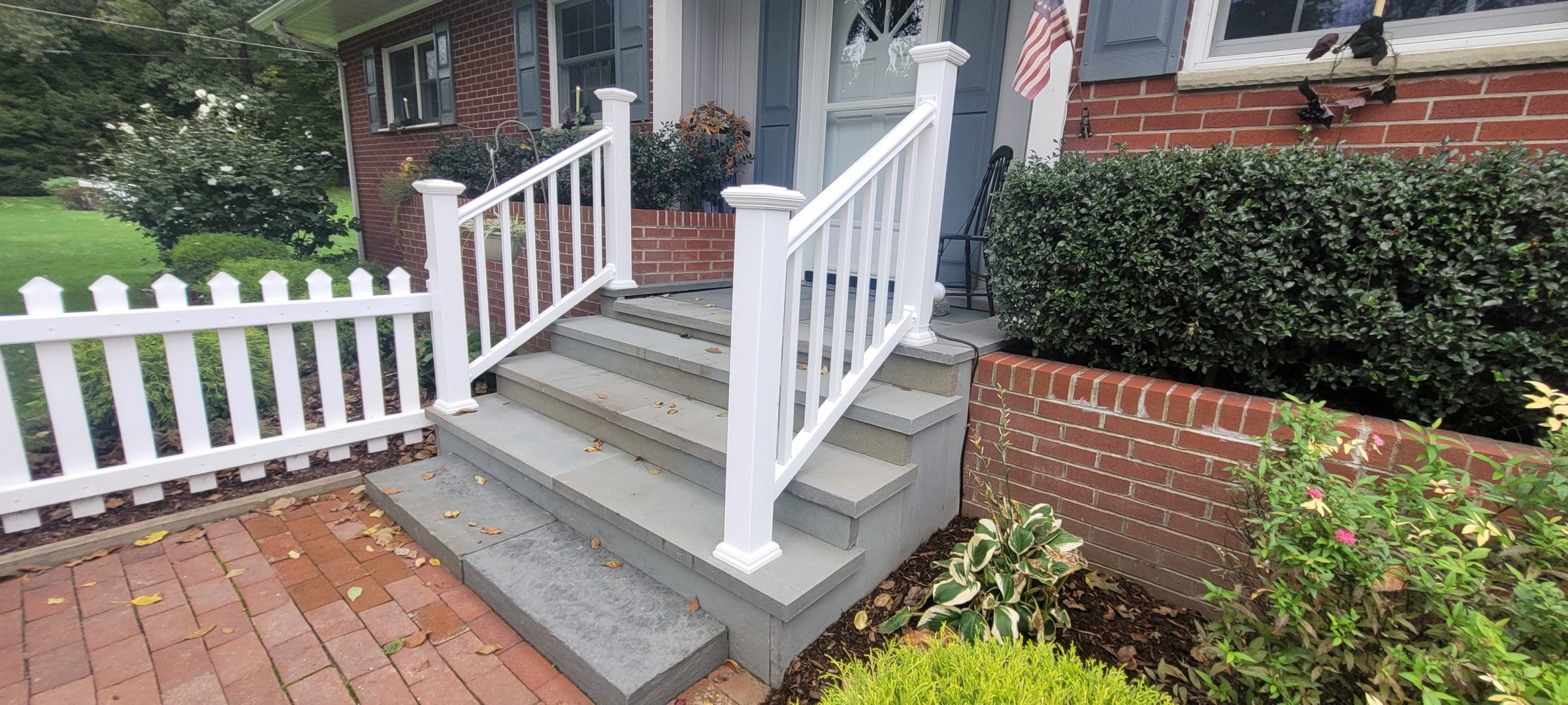Front porch with white railing and steps