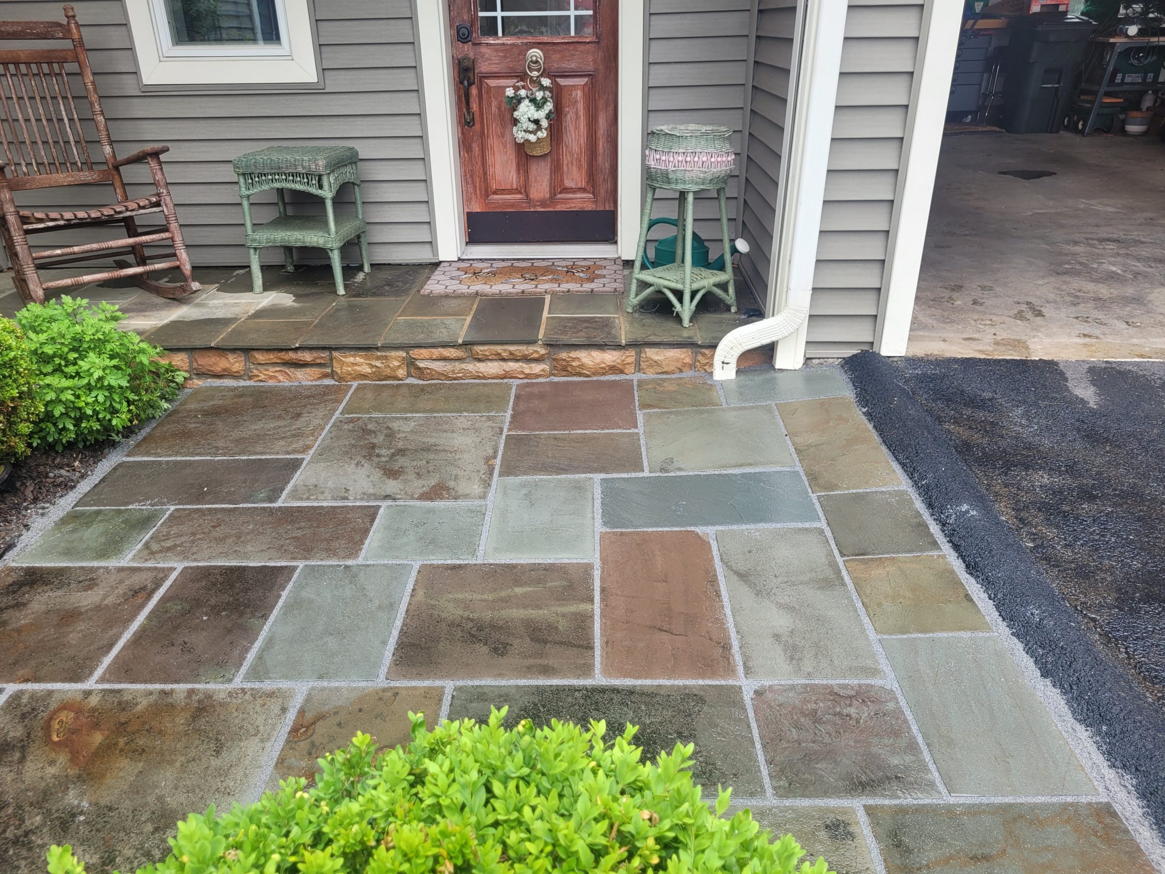 Front porch with stone tiles and wooden door