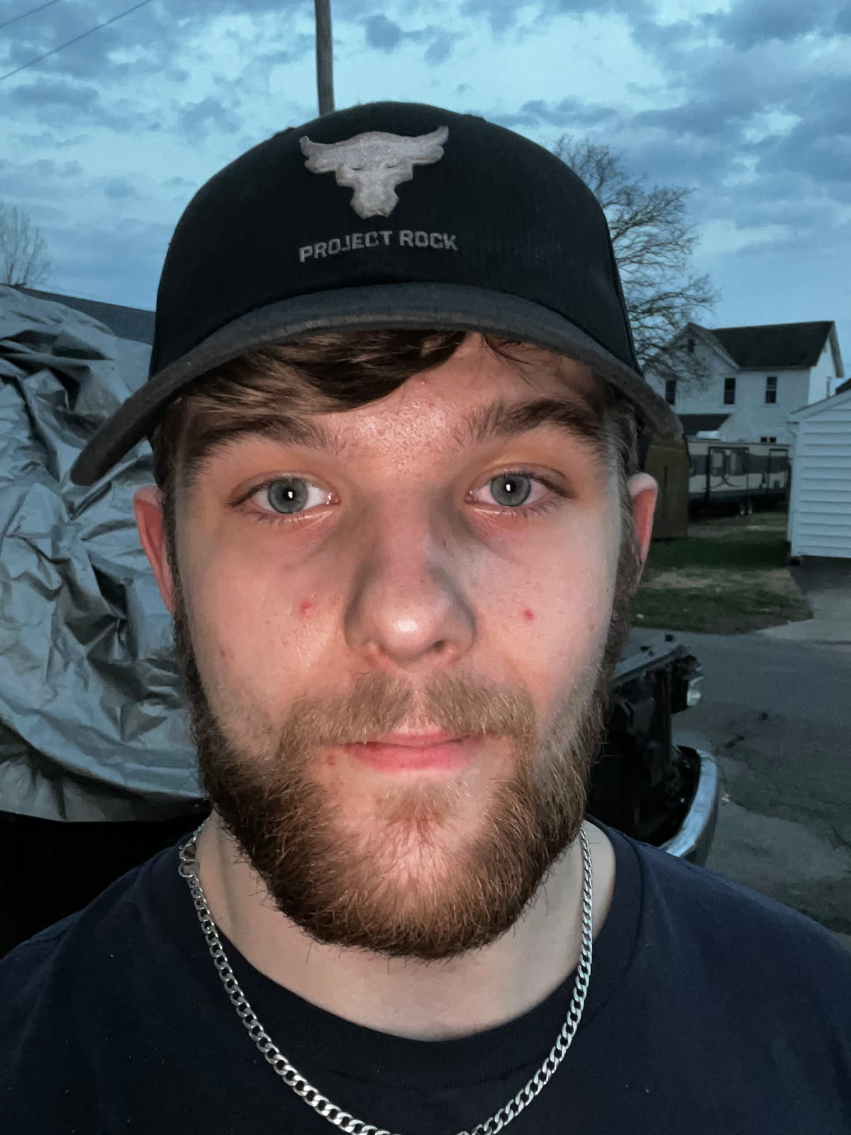 Man wearing Project Rock cap outdoors