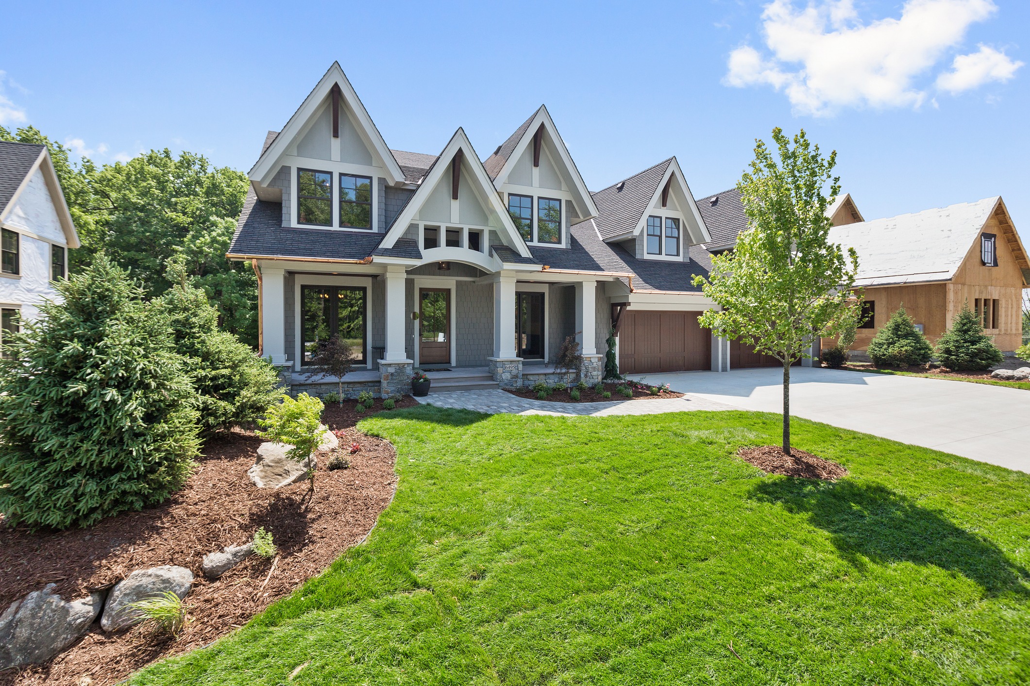 Modern Tudor-style house with landscaped yard