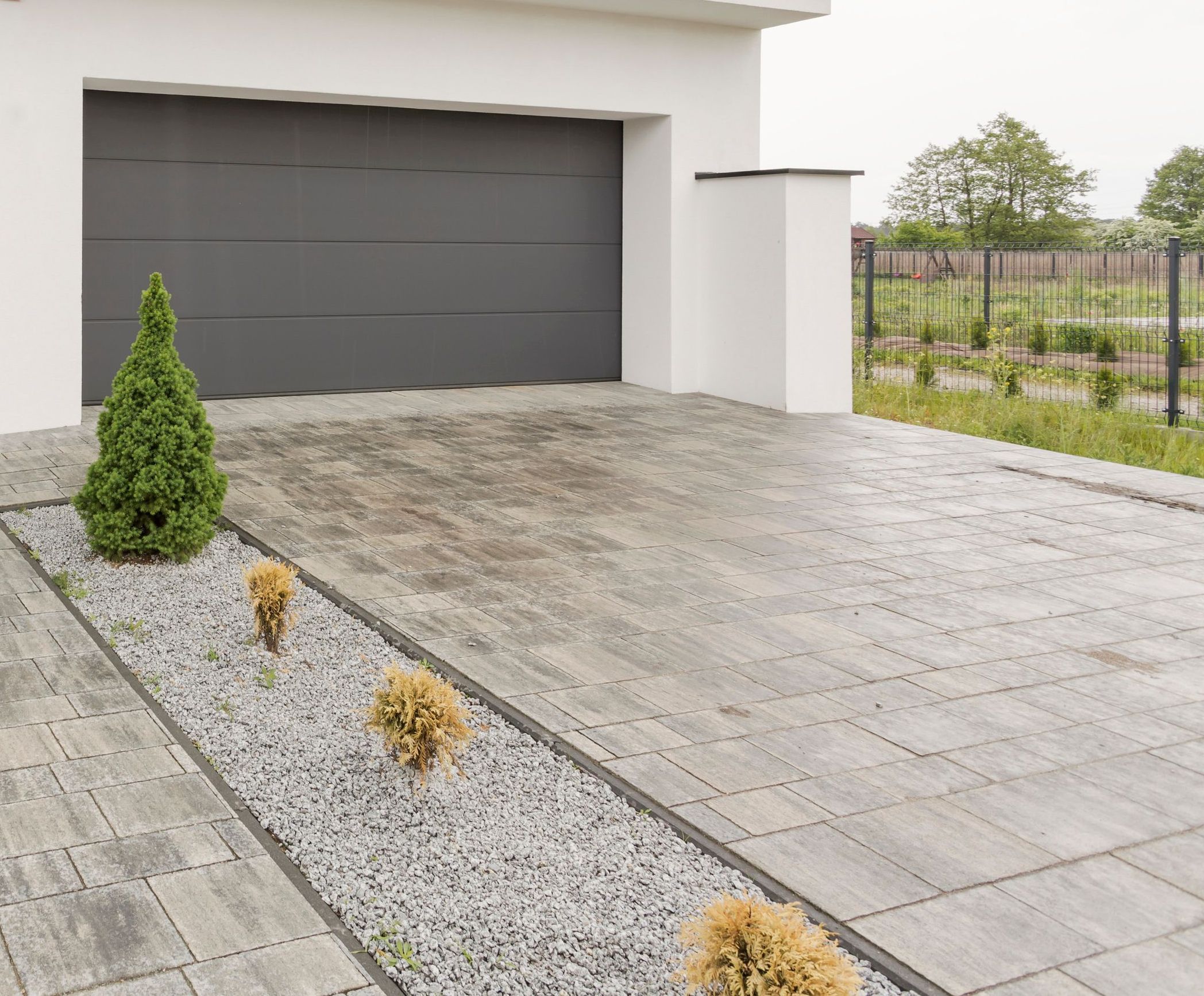 Modern home driveway with gray garage door