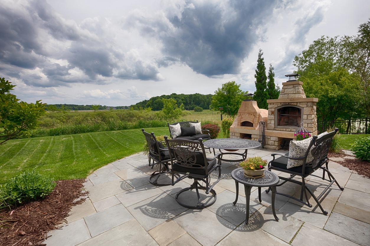 Patio with outdoor fireplace and chairs