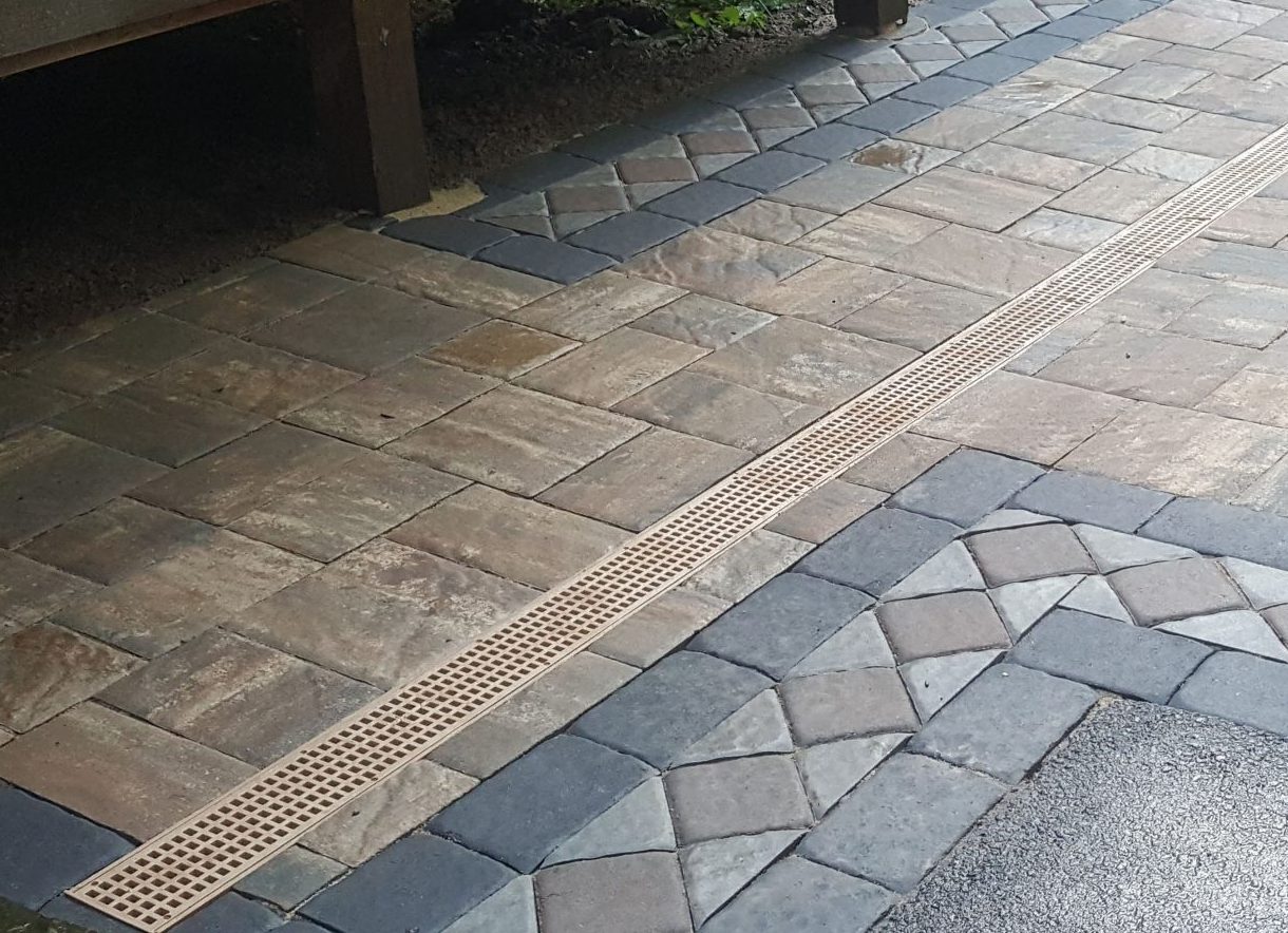 Decorative paved patio with drainage channel
