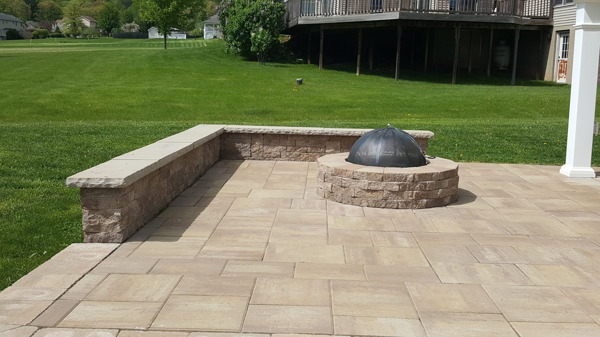 Outdoor patio with fire pit and lawn