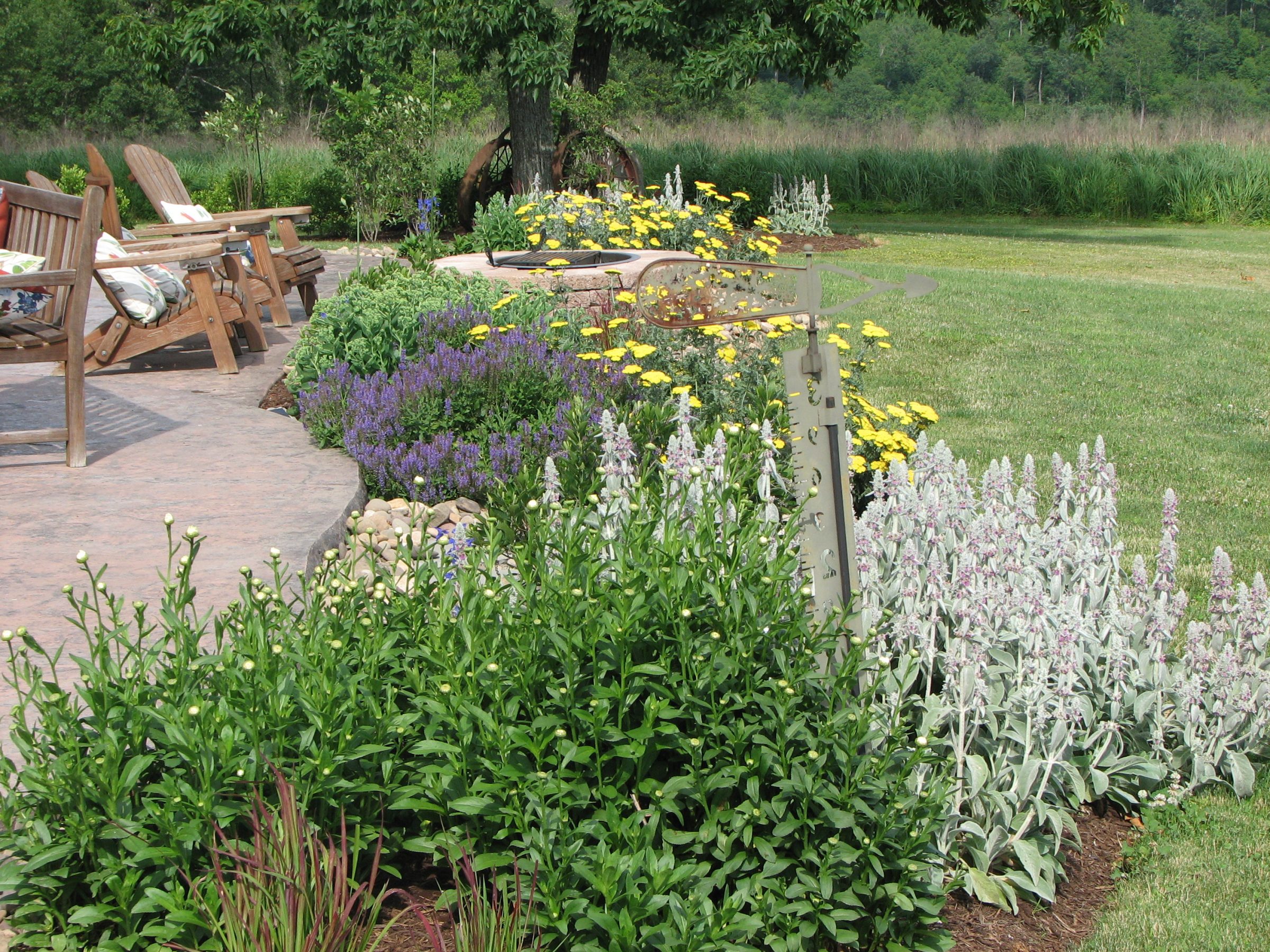 Colorful garden with wooden chairs
