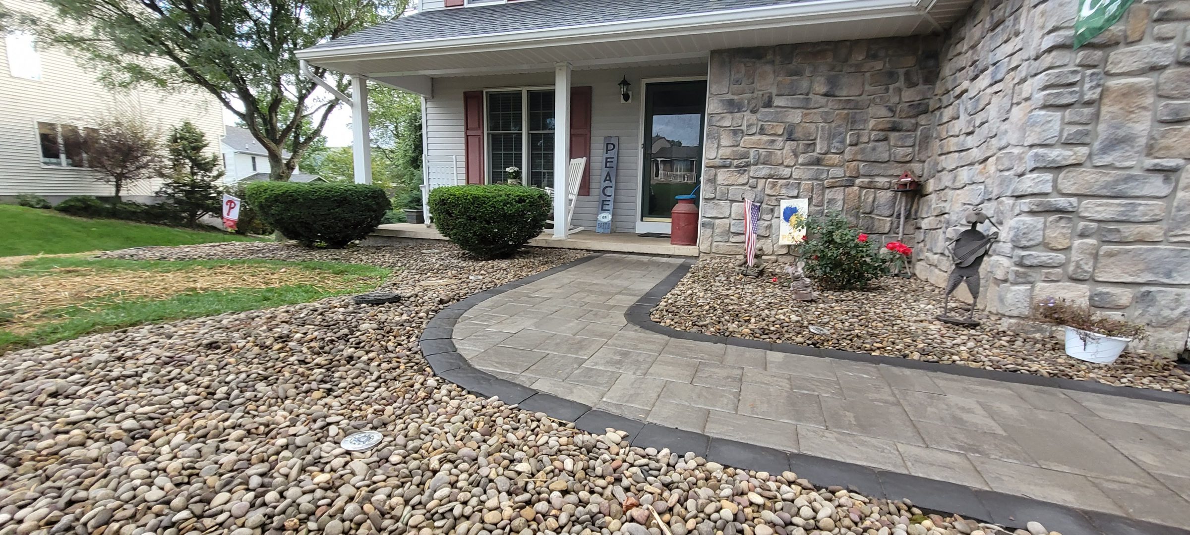 Front yard with stone path and porch.