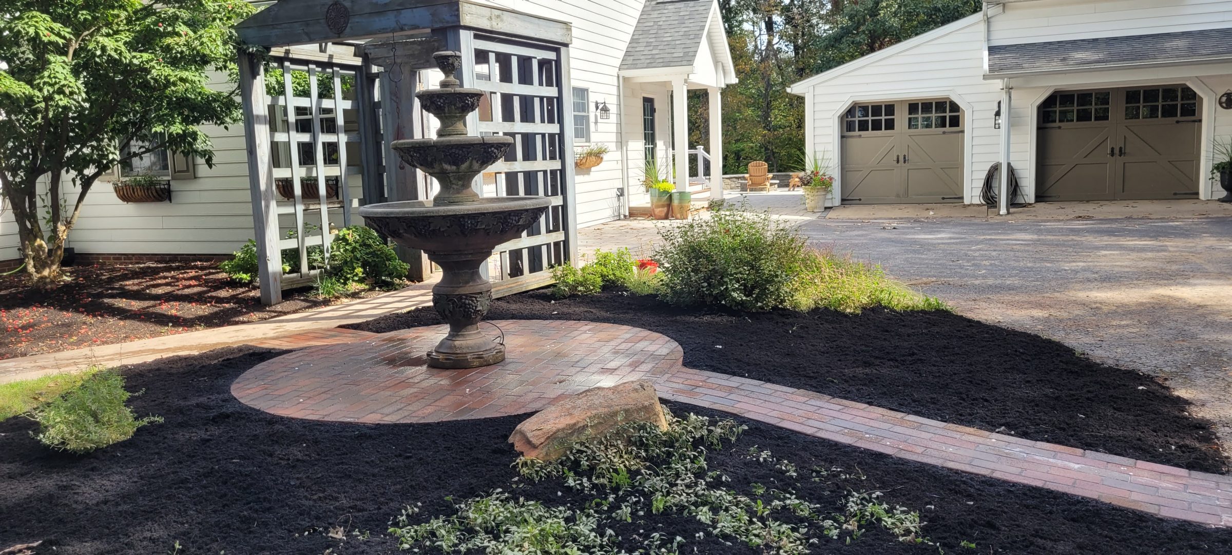 Tiered garden fountain on brick patio in front yard